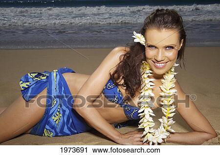 Stock Image - Hawaii, Kauai, Kealia, Beautiful Woman Dancing Hula On Ocean Shoreline.. Fotosearch