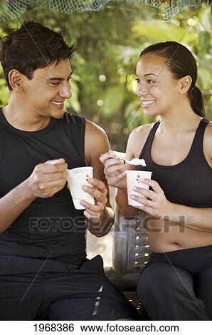 Stock Photograph - Hawaii, Kauai, Kilauea, Banana Joe's, Young Couple Enjoying A Frostie Treat.. Fotosearch