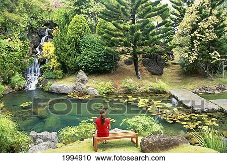 Hawaii, Kauai, Kilauea, Na Aina Kai Botanical Garden, Scenery Peaceful Waterfall And Pond, Woman Sitting On Bench View Large Photo Image Stock Image - Hawaii, Kauai, Kilauea, Na Aina Kai Botanical Garden, Scenery Peaceful Waterfall And Pond, Woman Sitting On Bench. Fotosearch