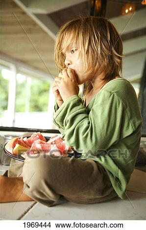 Hawaii, Kauai, Kilauea, Young Boy Sitting On Porch Eating Grapefruit. View Large Photo Image Picture - Hawaii, Kauai, Kilauea, Young Boy Sitting On Porch Eating Grapefruit.. Fotosearch