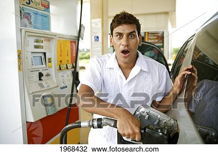 Hawaii, Kauai, Kilauea, Young Man Putting Gas In His Vehicle. View Large Photo Image Stock Image - Hawaii, Kauai, Kilauea, Young Man Putting Gas In His Vehicle.. Fotosearch