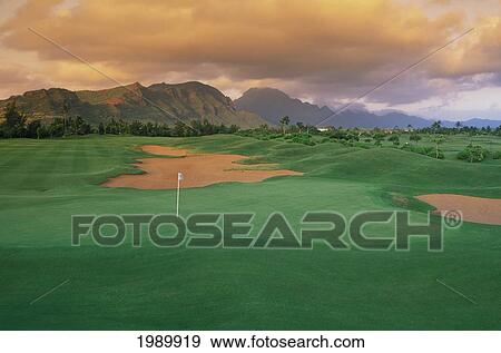 Stock Photo - Hawaii, Kauai, Lihue, Kauai Lagoons Resort, Kiele Golf Course, 10Th Hole, Orange Clouds And Sky. Fotosearch