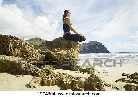 Picture - Hawaii, Kauai, Mahaulepu, Woman Doing Yoga.. Fotosearch