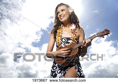 Stock Photo - Hawaii, Kauai, Menehune Pond, Beautiful Woman Playing The Ukulele.. Fotosearch
