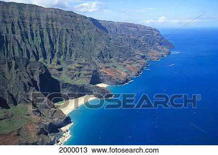 Stock Image - Hawaii, Kauai, Na Pali Coast, Aerial Of Mountains And Beach, Ocean Blue Skies C1550. Fotosearch