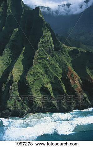 Hawaii, Kauai, Na Pali Coast, Aerial With Helicopter Along Mountainside, Ocean View Large Photo Image Stock Photo - Hawaii, Kauai, Na Pali Coast, Aerial With Helicopter Along Mountainside, Ocean. Fotosearch