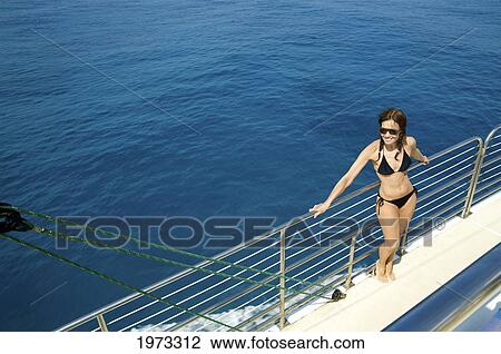 Stock Image - Hawaii, Kauai, Na Pali Coast, Beautiful Tourist Enjoying A Day Out On A Boat.. Fotosearch