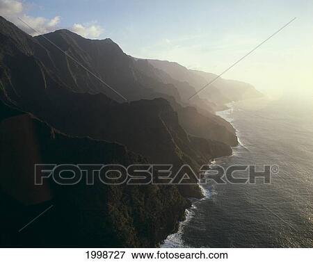Hawaii, Kauai, Na Pali Coast, Dramatic View Of Cliffs, Mist Over Ocean, B1546 View Large Photo Image Stock Photo - Hawaii, Kauai, Na Pali Coast, Dramatic View Of Cliffs, Mist Over Ocean, B1546. Fotosearch
