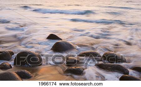 Picture - Hawaii, Kauai, Na Pali Coast, Evening Light Over Kalalau Beach, Long Exposure On Ocean And Rocks.. Fotosearch