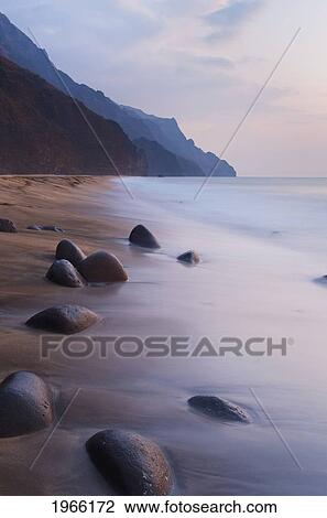 Stock Image - Hawaii, Kauai, Na Pali Coast, Evening Light Over Kalalau Beach, Long Exposure.. Fotosearch