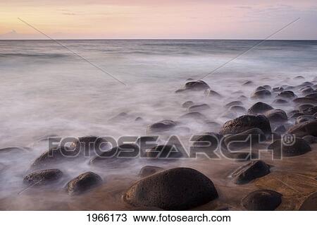 Stock Image - Hawaii, Kauai, Na Pali Coast, Evening Light Over Kalalau Beach, Long Exposure On Ocean And Rocks.. Fotosearch