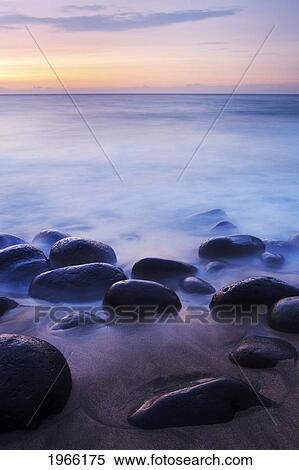 Stock Photography - Hawaii, Kauai, Na Pali Coast, Evening Light Over Kalalau Beach, Long Exposure On Ocean And Rocks.. Fotosearch
