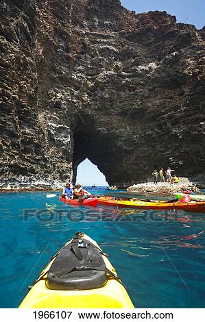 Stock Photo - Hawaii, Kauai, Na Pali Coast, Group Of Kayakers Exploring Sea Cave Along Coastline. Editorial Use Only.. Fotosearch