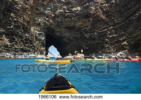 Hawaii, Kauai, Na Pali Coast, Group Of Kayakers Exploring Sea Cave Along Coastline. Editorial Use Only. View Large Photo Image Stock Photograph - Hawaii, Kauai, Na Pali Coast, Group Of Kayakers Exploring Sea Cave Along Coastline. Editorial Use Only.. Fotosearch