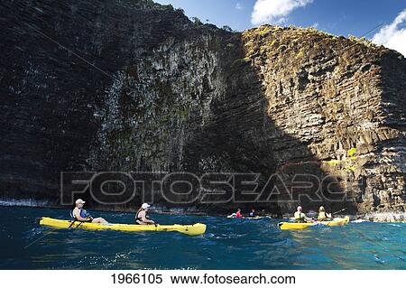 Stock Photography - Hawaii, Kauai, Na Pali Coast, Group Of Kayakers Paddling Along Coastal Cliffs. Editorial Use Only.. Fotosearch