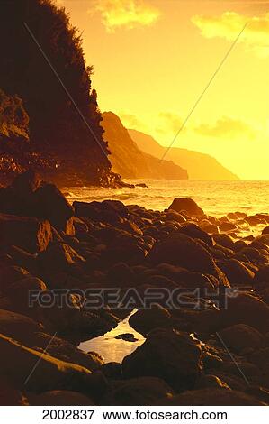 Hawaii, Kauai, Na Pali Coast, Sunset Along Rocky Shoreline With Tide Pool, Golden Yellow Sky View Large Photo Image Stock Photo - Hawaii, Kauai, Na Pali Coast, Sunset Along Rocky Shoreline With Tide Pool, Golden Yellow Sky. Fotosearch