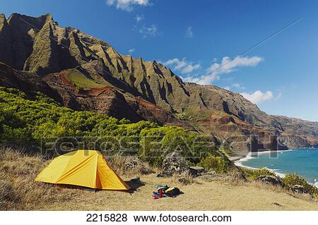 Stock Photo - Hawaii, Kauai, Na Pali Coast, View of the Kalalau Mountains, Campisite and tent.. Fotosearch