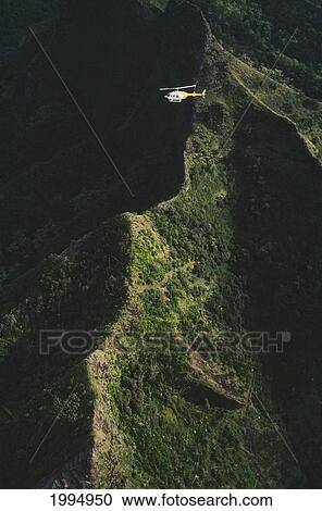 Stock Image - Hawaii, Kauai, Napali Coast Aerial Along Rugged Cliffs, Helicopter Tour In Flight. Fotosearch