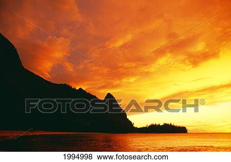 Stock Photo - Hawaii, Kauai, Napali Coast, Bali Hai At Sunset, Bright Orange Sky And Calm Ocean.. Fotosearch