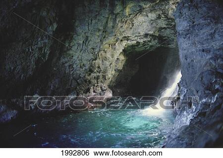 Stock Photograph - Hawaii, Kauai, Napali Coast Detail, Closeup Of Seacave With Waterfall Alongside. Fotosearch