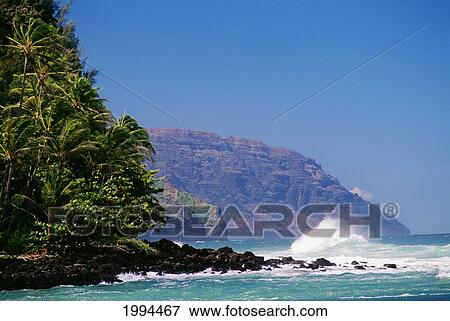 Stock Photo - Hawaii, Kauai, Napali Coast Storm Surf Pounding Along Shoreline, Blue Skies. Fotosearch