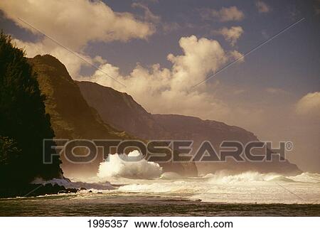 Stock Photo - Hawaii, Kauai, Napali Coast Storm Surf Pounding Along Shoreline, Moody Skies. Fotosearch