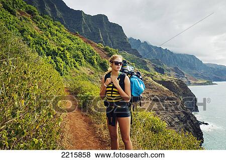 Stock Photo - Hawaii, Kauai, Napali Coast, Woman Hiking on the Napali Coast Trail.. Fotosearch