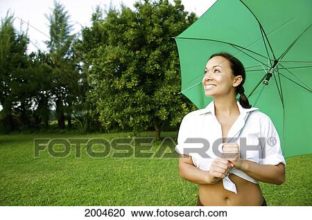 Hawaii, Kauai, North Shore, A Young Woman Opens Her Umbrella, Preparing For Rain. View Large Photo Image Stock Image - Hawaii, Kauai, North Shore, A Young Woman Opens Her Umbrella, Preparing For Rain.. Fotosearch