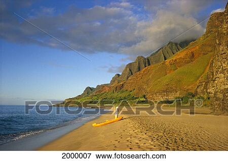 Stock Photo - Hawaii, Kauai, North Shore, Kalalau Valley, Kayaker On Beach, Golden Light. Fotosearch
