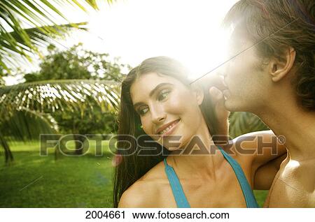 Hawaii, Kauai, North Shore, Man Whispers Secret Into Woman's Ear. View Large Photo Image Stock Image - Hawaii, Kauai, North Shore, Man Whispers Secret Into Woman's Ear.. Fotosearch