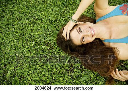 Picture - Hawaii, Kauai, North Shore, Model Poses In Grass.. Fotosearch