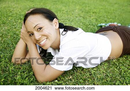 Hawaii, Kauai, North Shore, Model Poses Laying In Grass. View Large Photo Image Stock Image - Hawaii, Kauai, North Shore, Model Poses Laying In Grass.. Fotosearch