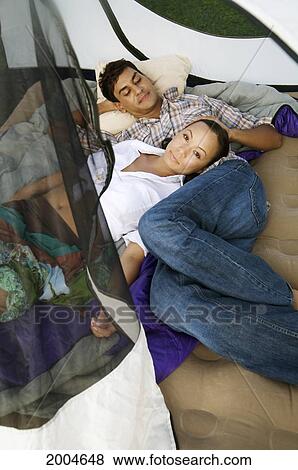 Hawaii, Kauai, North Shore, /Nyoung Couple Rest In Their Tent. View Large Photo Image Stock Photo - Hawaii, Kauai, North Shore, /Nyoung Couple Rest In Their Tent.. Fotosearch