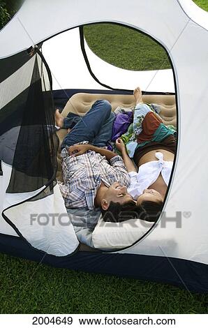Hawaii, Kauai, North Shore, /Nyoung Couple Share A Nap In Their Tent. View Large Photo Image Stock Photo - Hawaii, Kauai, North Shore, /Nyoung Couple Share A Nap In Their Tent.. Fotosearch