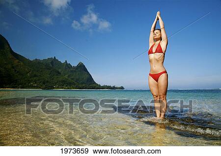 Hawaii, Kauai, North Shore, Tunnels Beach, Woman Doing Yoga. View Large Photo Image Stock Photo - Hawaii, Kauai, North Shore, Tunnels Beach, Woman Doing Yoga.. Fotosearch