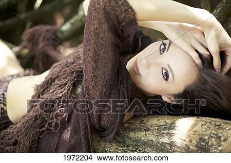 Picture - Hawaii, Kauai, North Shore, Waikoko, Asian Woman Models Fashion At The Beach.. Fotosearch