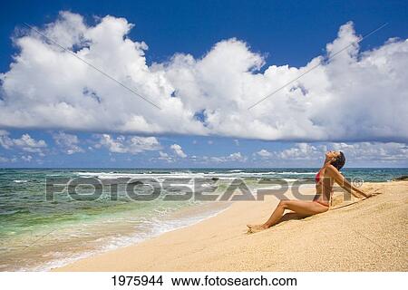 Hawaii, Kauai, North Shore, Woman Sitting On Beach. View Large Photo Image Picture - Hawaii, Kauai, North Shore, Woman Sitting On Beach.. Fotosearch
