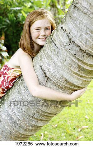 Hawaii, Kauai, North Shore, Young Girl With Red Hair And Freckles Leans Against A Palm Tree. View Large Photo Image Stock Photograph - Hawaii, Kauai, North Shore, Young Girl With Red Hair And Freckles Leans Against A Palm Tree.. Fotosearch