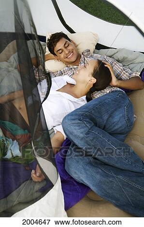 Hawaii, Kauai, North Shore, Young Couple Admire Eachother In Their Tent. View Large Photo Image Stock Photo - Hawaii, Kauai, North Shore, Young Couple Admire Eachother In Their Tent.. Fotosearch