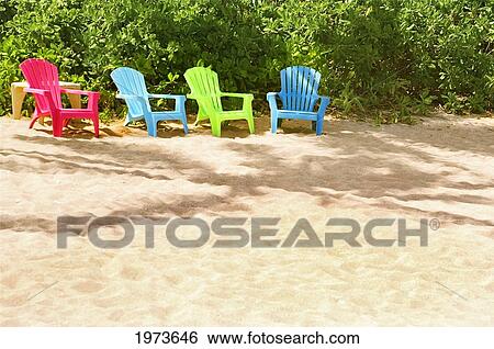 Stock Photograph - Hawaii, Kauai, Pila'a, Four Colorful Chairs Rest On The Sand.. Fotosearch