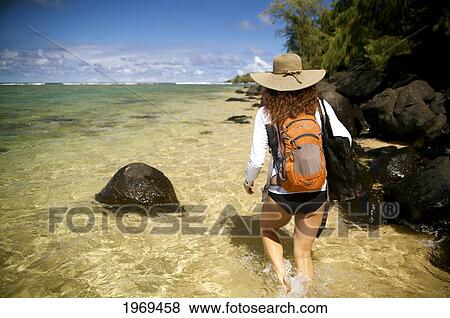 Hawaii, Kauai, Pila'a, Woman Hiking Through Water. View Large Photo Image Stock Photo - Hawaii, Kauai, Pila'a, Woman Hiking Through Water.. Fotosearch
