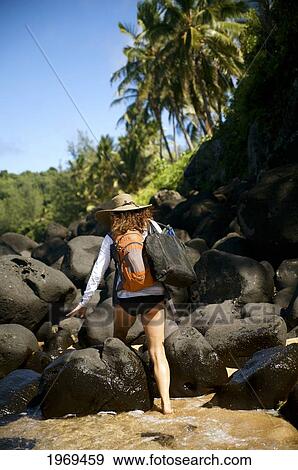 Hawaii, Kauai, Pila'a, Woman Hiking Through Water. View Large Photo Image Stock Photo - Hawaii, Kauai, Pila'a, Woman Hiking Through Water.. Fotosearch
