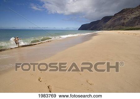 Stock Photo - Hawaii, Kauai, Polihale Beach, A Couple Enjoy The Ocean.. Fotosearch