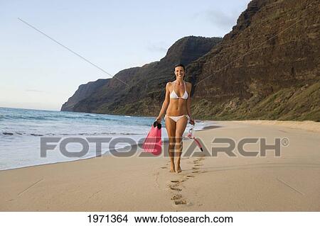 Hawaii, Kauai, Polihale Beach, Woman Walking Along Sandy Shore With Snorkel Gear, Evening Glow. View Large Photo Image Picture - Hawaii, Kauai, Polihale Beach, Woman Walking Along Sandy Shore With Snorkel Gear, Evening Glow.. Fotosearch