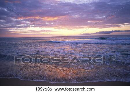 Stock Photography - Hawaii, Kauai, Polihale Sunset Over Beach, Pink And Orange Clouds, Waves A32D. Fotosearch