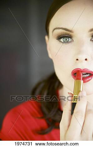 Hawaii, Kauai, Portrait Of A Beautiful Woman In Red Applying Lipstick. View Large Photo Image Stock Image - Hawaii, Kauai, Portrait Of A Beautiful Woman In Red Applying Lipstick.. Fotosearch