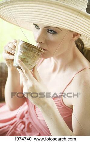 Hawaii, Kauai, Portrait Of A Beautiful Woman In A Pink Sundress Drinking Tea. View Large Photo Image Stock Image - Hawaii, Kauai, Portrait Of A Beautiful Woman In A Pink Sundress Drinking Tea.. Fotosearch