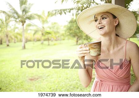 Hawaii, Kauai, Portrait Of A Beautiful Woman In A Pink Sundress Drinking Tea. View Large Photo Image Stock Photo - Hawaii, Kauai, Portrait Of A Beautiful Woman In A Pink Sundress Drinking Tea.. Fotosearch