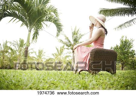 Hawaii, Kauai, Portrait Of A Beautiful Woman In A Pink Sundress Drinking Tea. View Large Photo Image Stock Photograph - Hawaii, Kauai, Portrait Of A Beautiful Woman In A Pink Sundress Drinking Tea.. Fotosearch