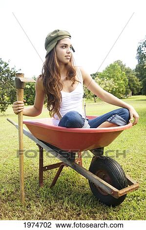 Stock Image - Hawaii, Kauai, Portrait Of Attractive Young Woman In A Crate.. Fotosearch
